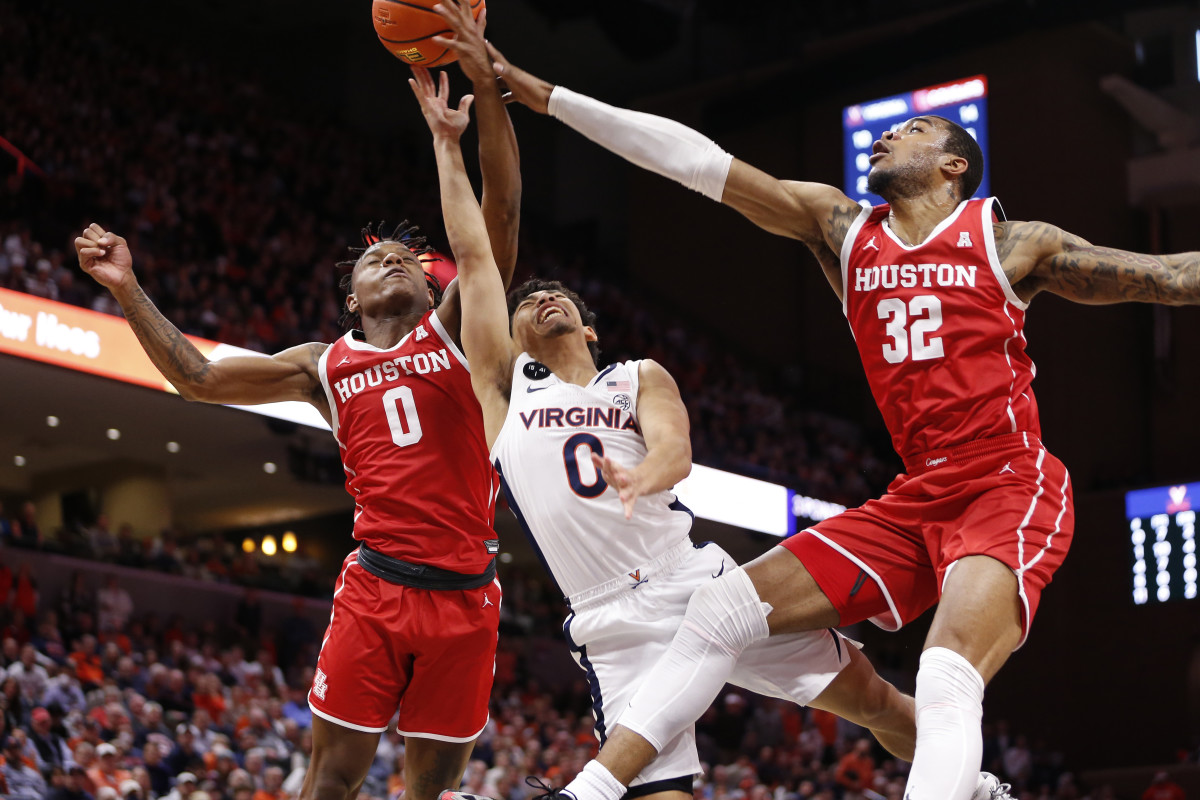 Dec 17, 2022; Charlottesville, Virginia, USA; Houston Cougars forward Reggie Chaney (32) and Cougars guard Marcus Sasser (0) block a shot by Virginia Cavaliers guard Kihei Clark (0) during the second half at John Paul Jones Arena. Mandatory Credit: Amber Searls-USA TODAY Sports